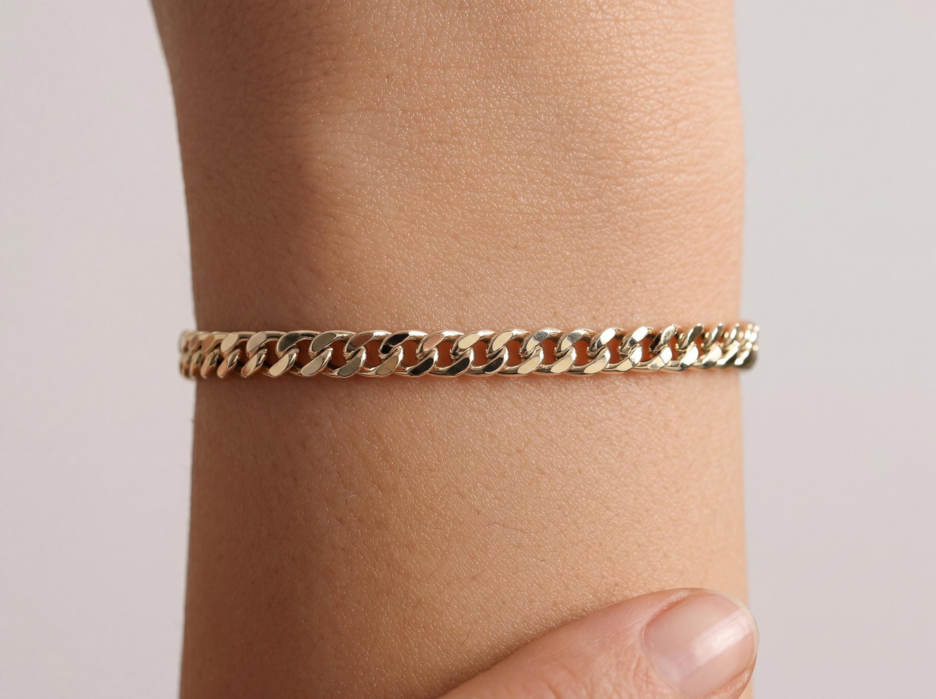 14k real gold cuban link chain bracelet 4mm worn on wrist, minimal solid gold bracelet for everyday elegance