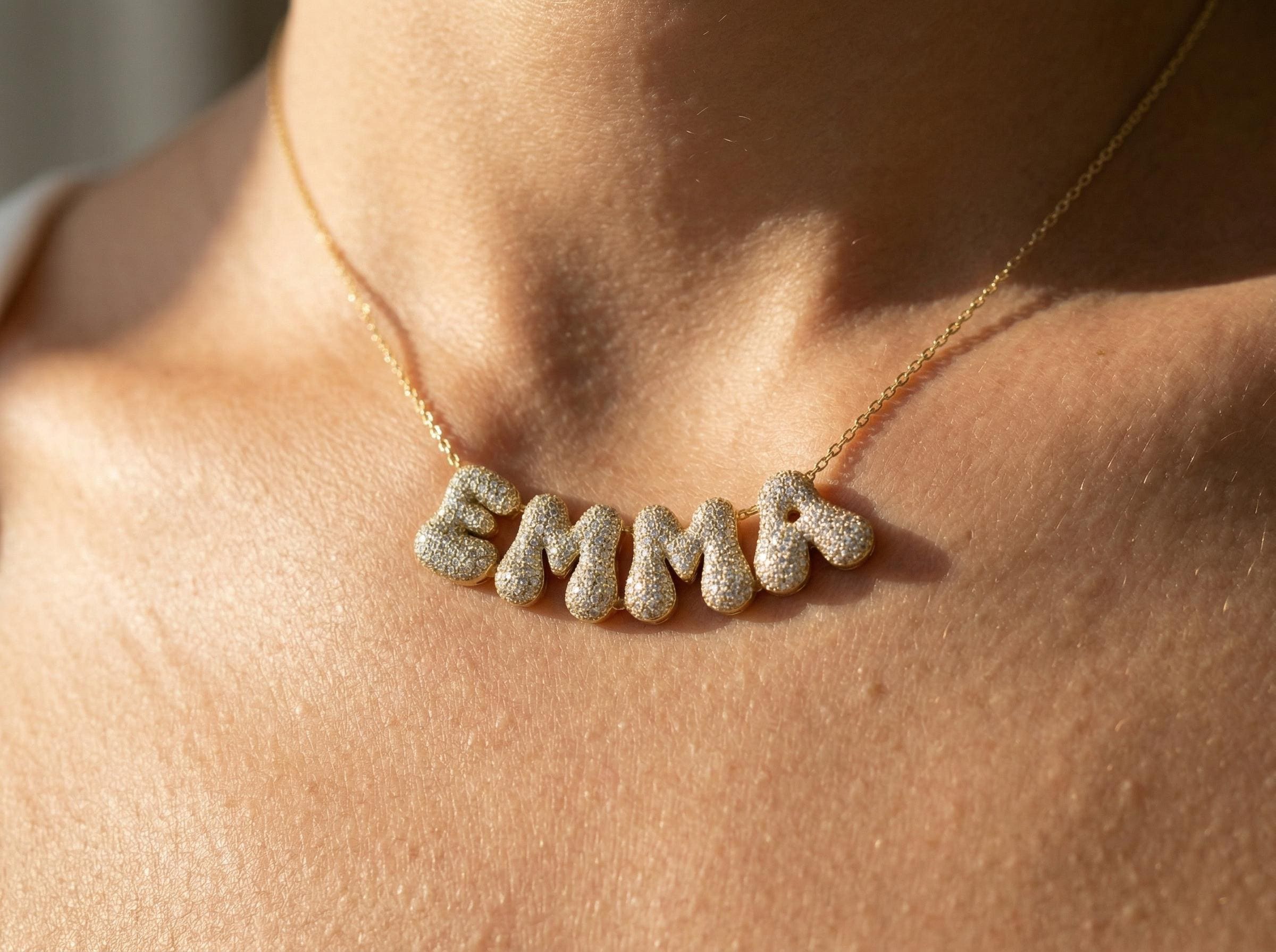 Personalized EMMA bubble letter necklace on model close up